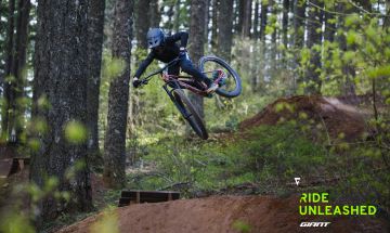 Youth mountain biker jumping on a trail