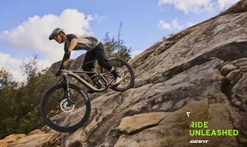 Mountain biker rides down rock garden